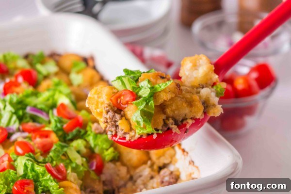 Freshly baked Big Mac Tater Tot Casserole, served in a dish with visible crispy tater tots.