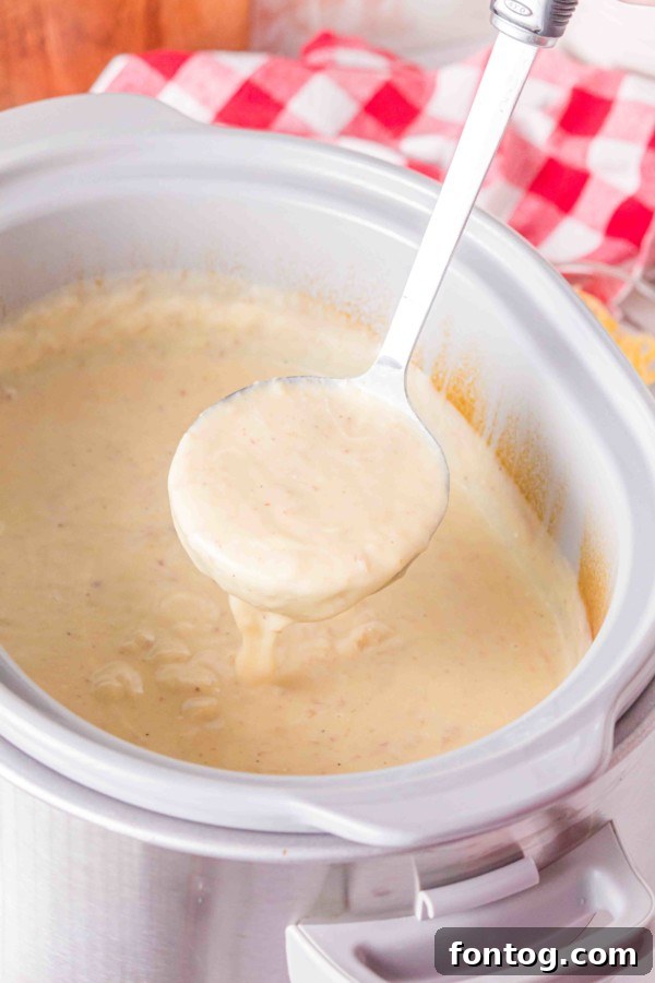 Close-up of diced potatoes and broth in a slow cooker