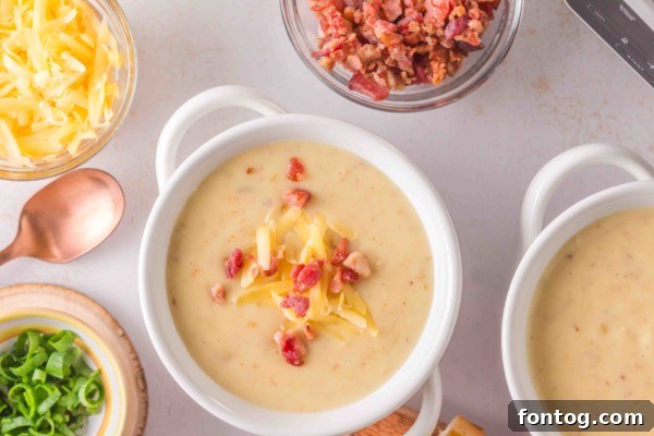 Handheld potato masher in a slow cooker with mashed potatoes