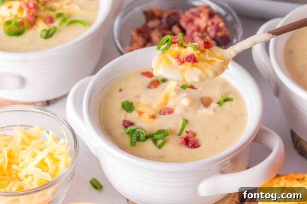 Bowls of gluten-free slow cooker baked potato soup ready for serving