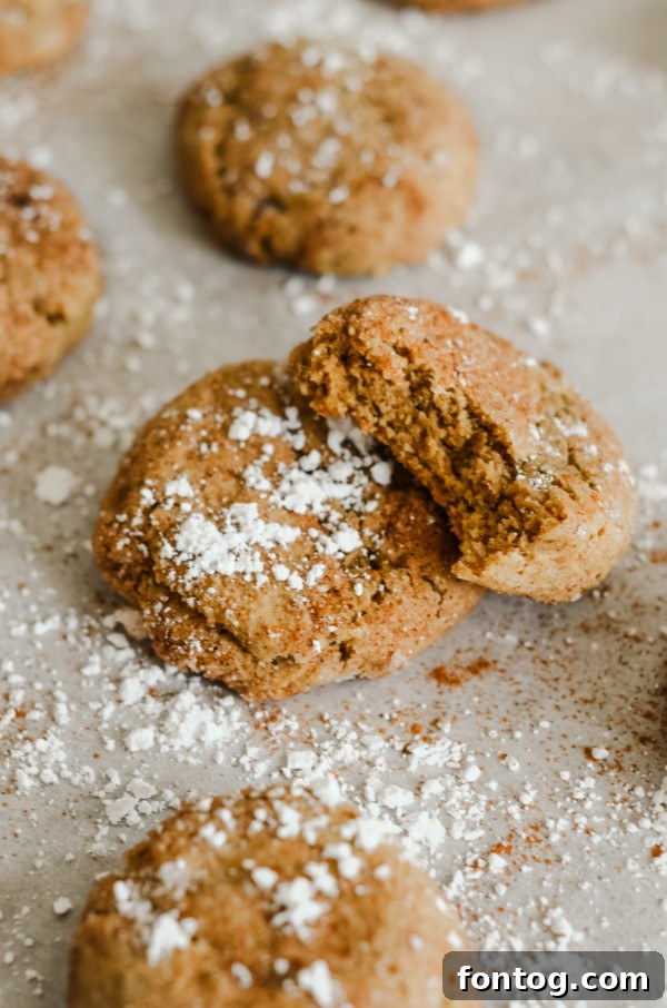 Delightfully fluffy gluten-free pumpkin spice cookies on a cooling rack, perfectly capturing the essence of fall baking.