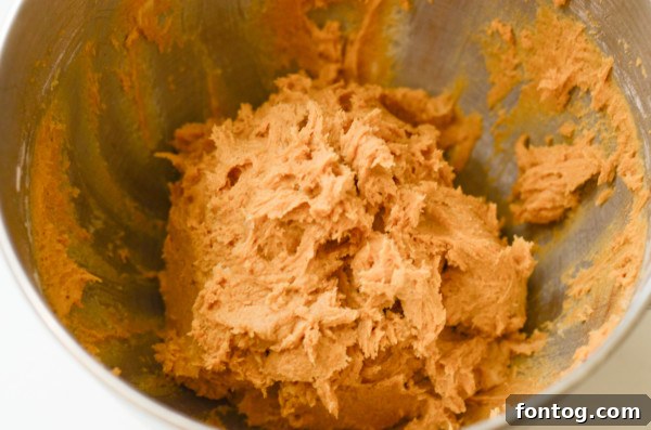 Canned pumpkin puree alongside pumpkin pie spice, highlighting the core flavors of the cookies.