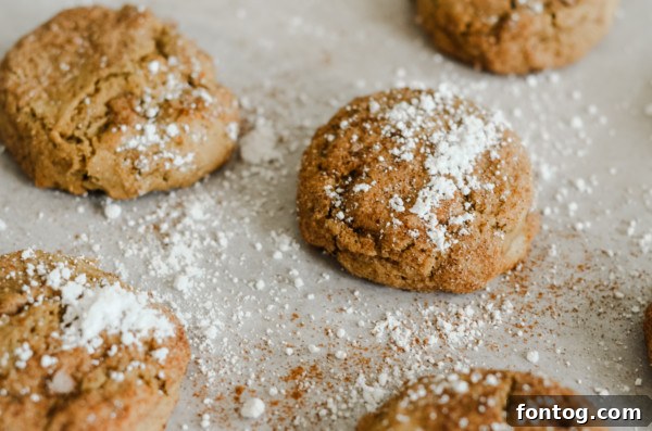 A close-up of a stack of freshly baked gluten-free pumpkin spice cookies, showing their soft texture.