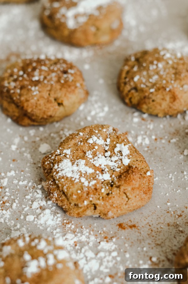 A beautifully arranged plate of gluten-free pumpkin spice cookies, some drizzled with glaze, others with toppings.