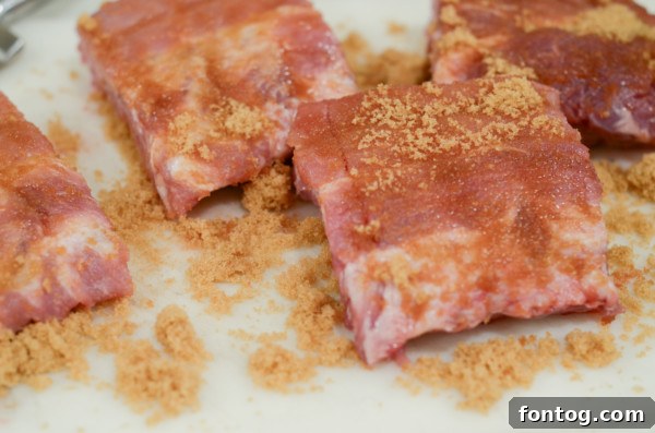 Pork ribs coated with a generous layer of brown sugar before slow cooking.