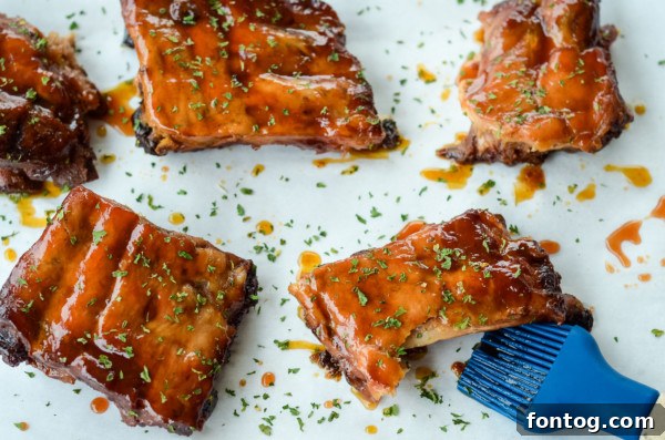 Perfectly cooked apple bbq ribs, glistening with sauce, just removed from the slow cooker.
