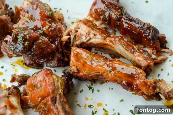 Sliced slow cooker apple bbq ribs arranged and ready to be served, showing their tender interior.