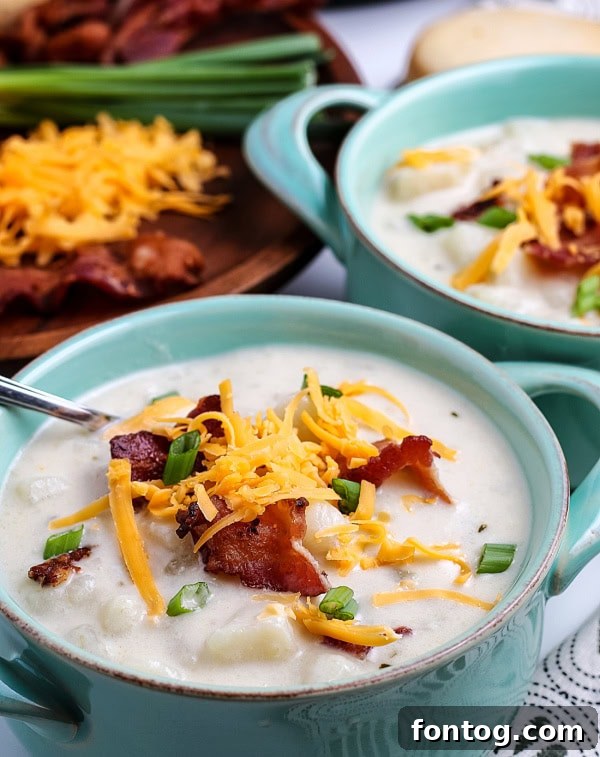 A beautifully presented bowl of gluten-free pressure cooker potato soup, garnished with crispy bacon and green onions.