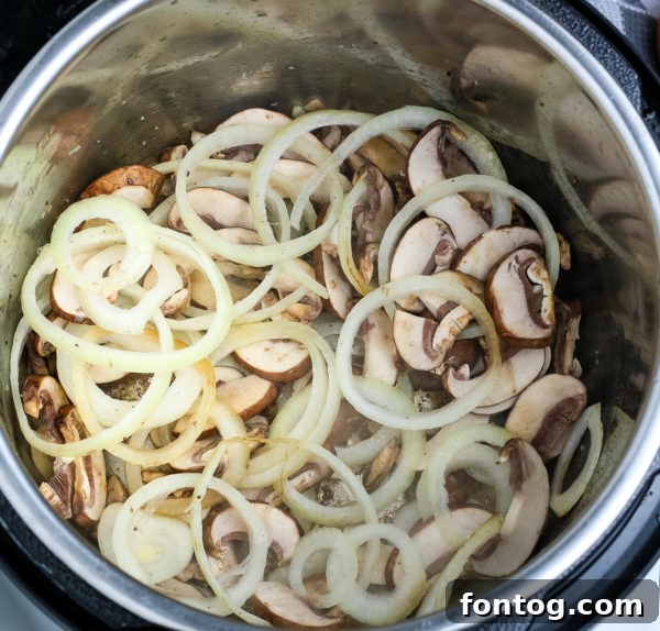Ingredients being combined in a pressure cooker for pork chops