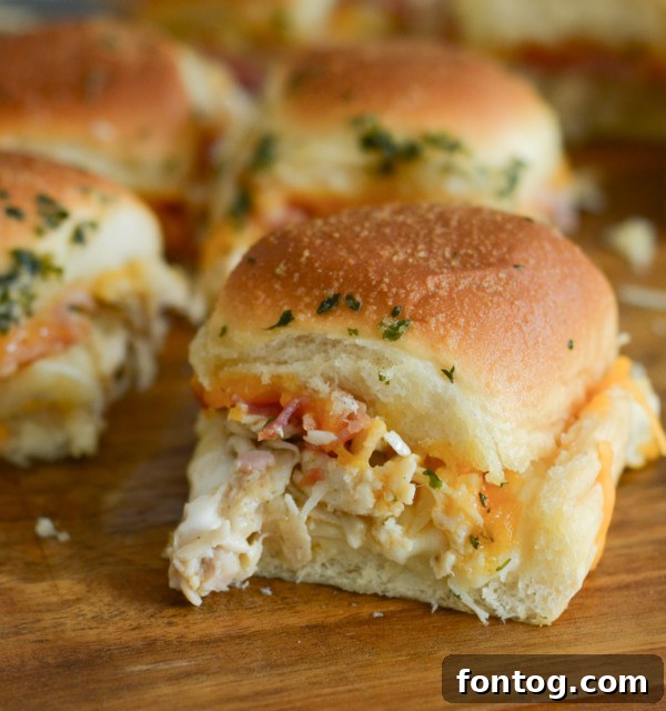 No-Fuss Chicken Bacon Ranch Minis 2 Oven-baked Chicken Bacon Ranch Sliders ready to serve on a platter.