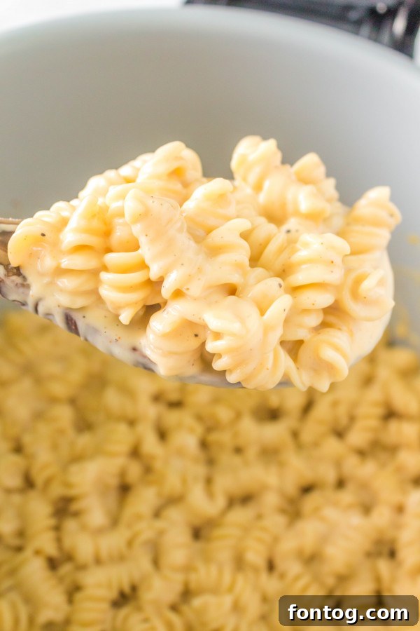 Close-up of creamy pressure cooker mac and cheese with fresh herbs