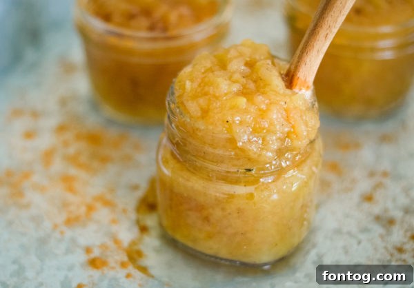 Hot, steaming applesauce freshly cooked in a pressure cooker pot