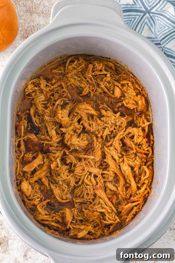 slow cooker hot honey chicken served as a sandwich