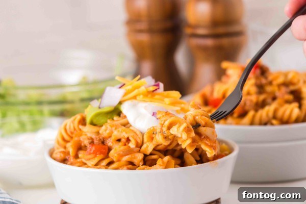A bowl of gluten-free slow cooker taco pasta with toppings