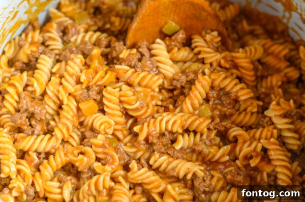 A bowl of pressure cooker taco pasta with cheese and corn.