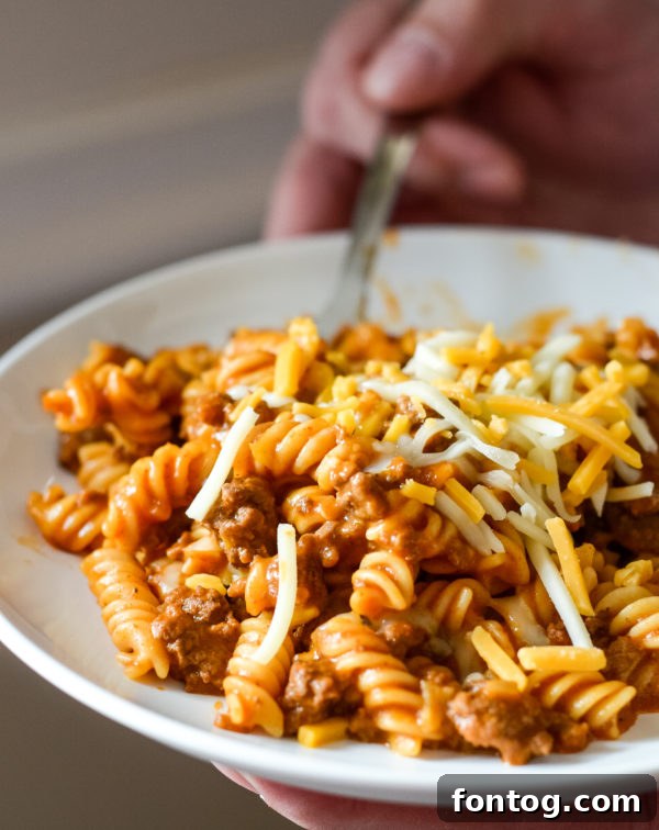 Pressure cooker taco pasta, gluten-free, in a container for leftovers.