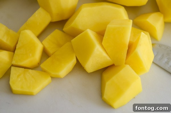 Boiling peeled and quartered potatoes for make-ahead mashed potato recipe.