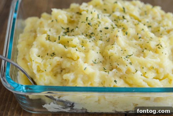 Close-up of creamy, gluten-free refrigerated mashed potatoes with a dollop of butter.