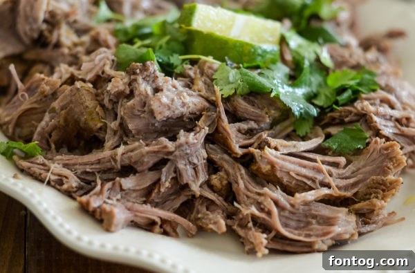 Effortless Pressure Cooker Pork Carnitas 4 Pressure cooker pork carnitas piled high with toppings in a taco