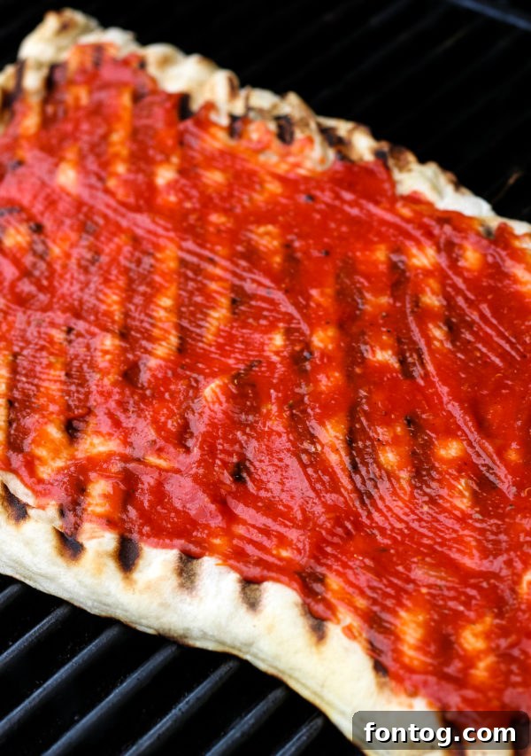 How to Make Grilled Pizza - Pizza dough cooking on a hot grill.
