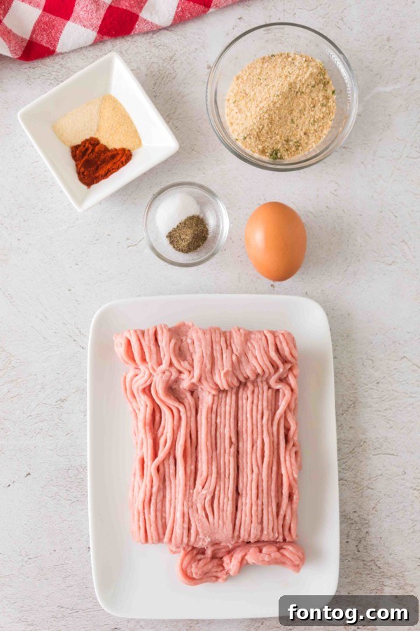 Ingredients for gluten-free baked turkey meatballs: ground turkey, breadcrumbs, egg, and spices.