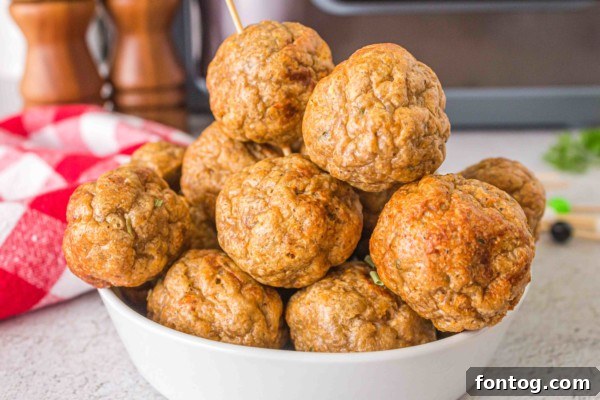 Plate of gluten-free baked turkey meatballs with breadcrumbs, garnished with parsley