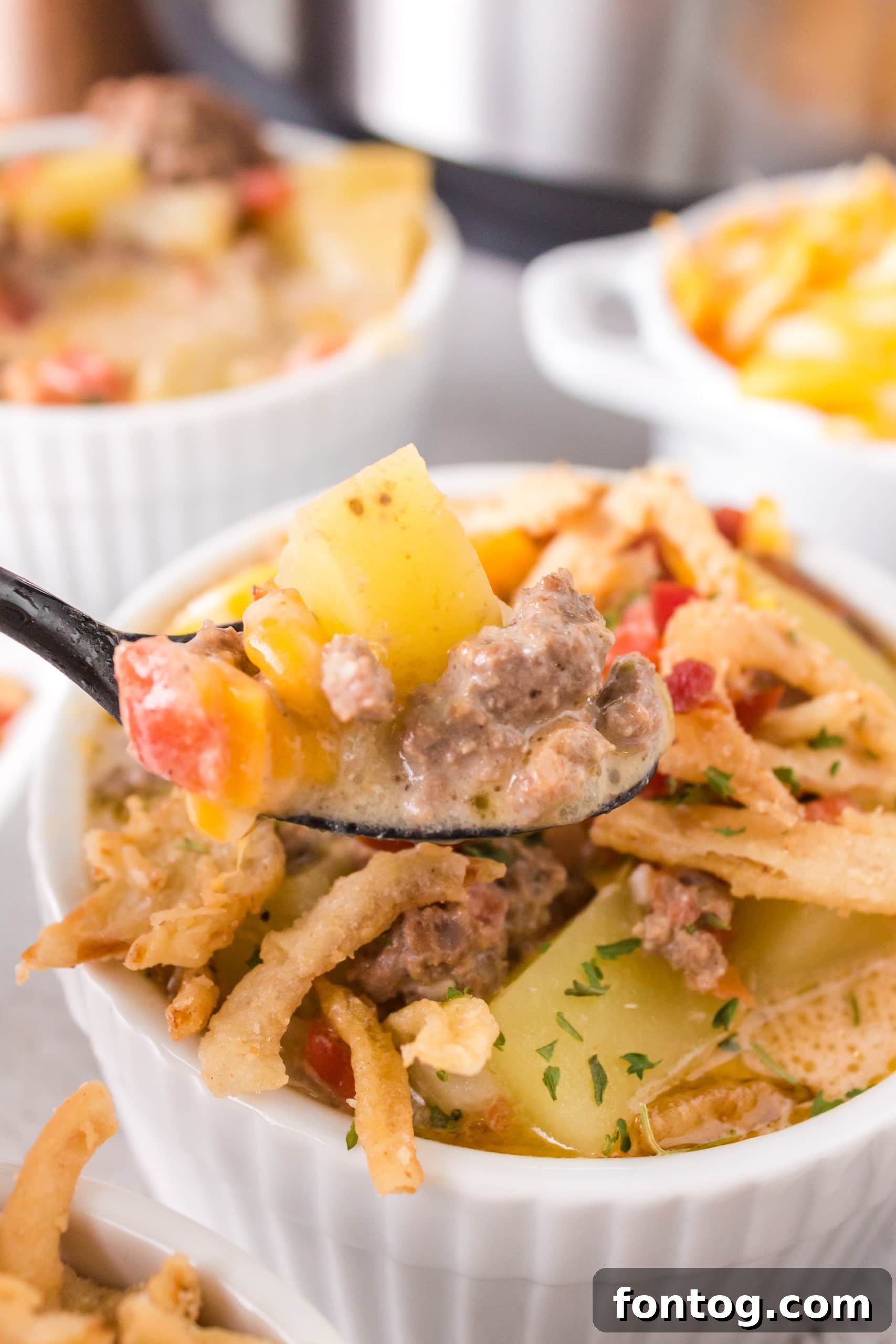 Cheeseburger soup with cheese and crackers on top.