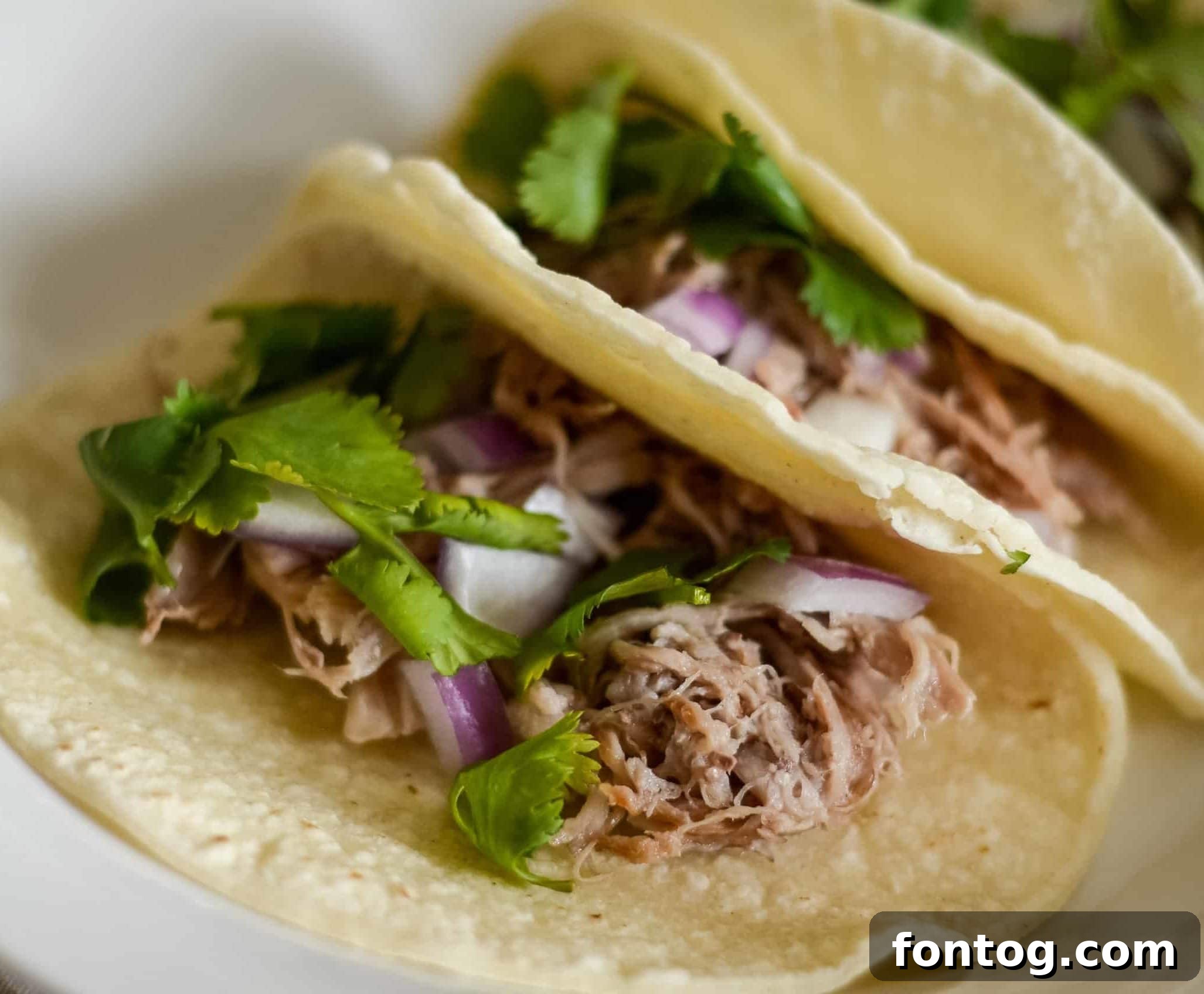 Pork street tacos on a cutting board.