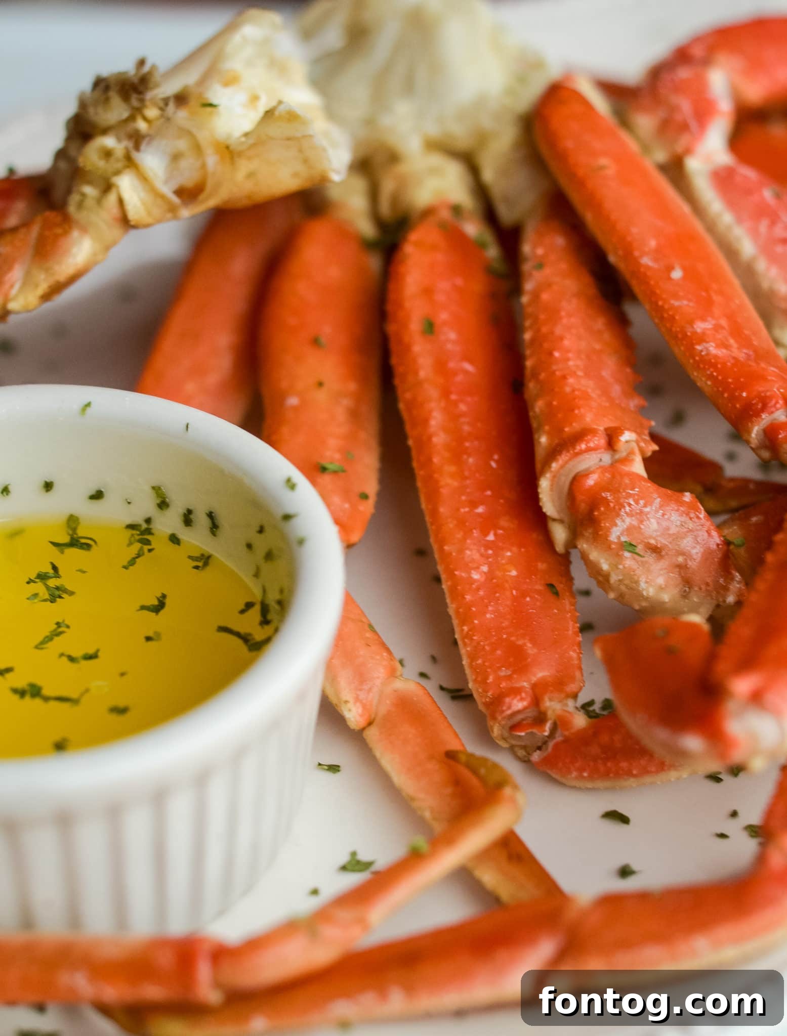Crab legs in a pot with corn and potatoes.