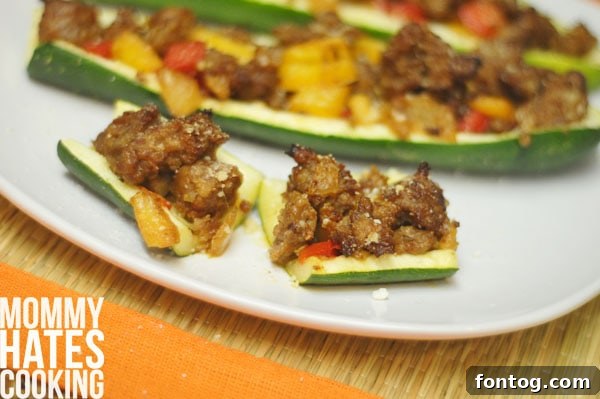 Close-up of baked zucchini boats, showcasing the cheesy topping and savory filling.
