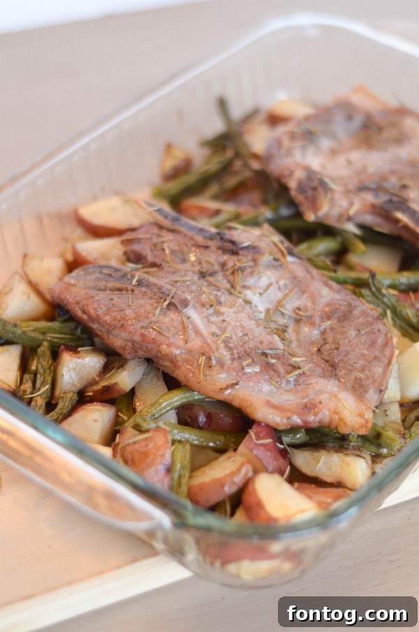 One-Pan Rosemary Pork Chops 4 One-Dish Rosemary Pork Chops baking in the oven with red potatoes