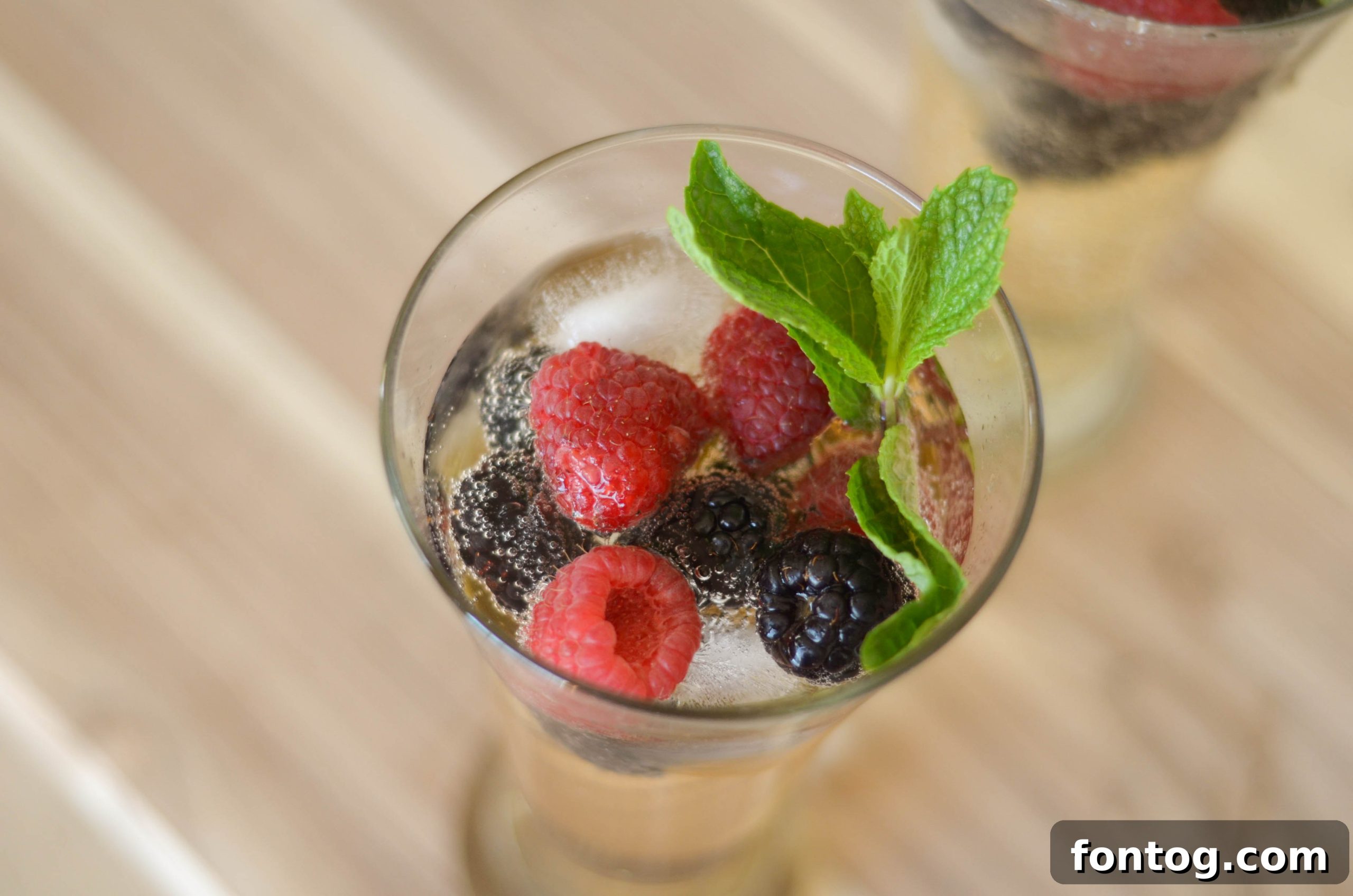 Ginger Berry Mocktail in a glass with berries and mint
