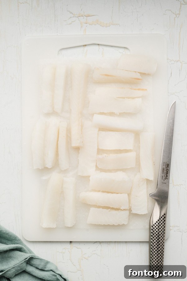raw white fish fillets cut for fish sticks