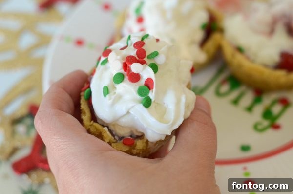 Close-up of Cherry Sugar Cookie Cups topped with cherry filling and whipped cream, ready to serve
