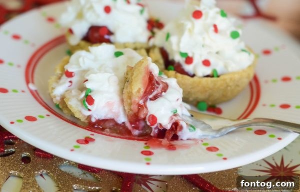 Platter of homemade Cherry Sugar Cookie Cups, garnished with sprinkles, for a holiday party