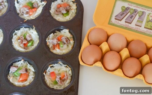 Breakfast Hash Brown Nests 5 Hash brown nests in a muffin tin, ready for fillings.