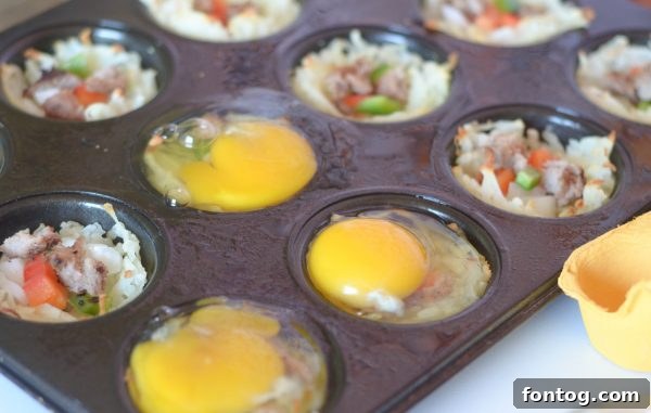 Breakfast Hash Brown Nests 7 Adding cooked sausage and diced vegetables to hash brown cups.