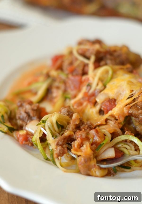 Flavorful Taco Zoodle Casserole with melted cheese and fresh herbs, ready to be served
