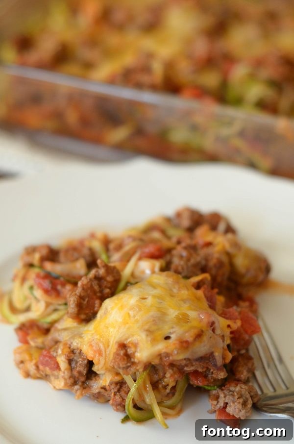 Taco Zoodle Casserole baking in the oven, with cheese bubbling and melting