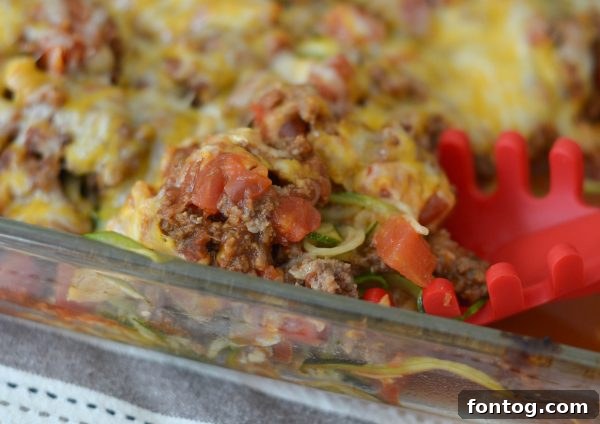 Individual serving of Taco Zoodle Casserole garnished with fresh cilantro