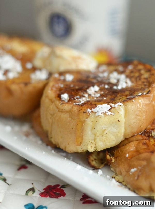 Velvety Maple French Toast Perfection 5 Creamy Maple French Toast Recipe - French toast soaking in custard in a baking dish.