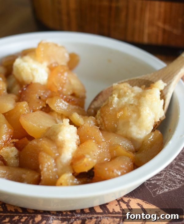 Three slices of Caramel Apple Magic Cobbler with a rich caramel drizzle