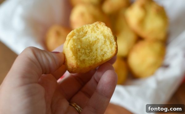 A basket full of golden air fryer hush puppies, perfectly cooked