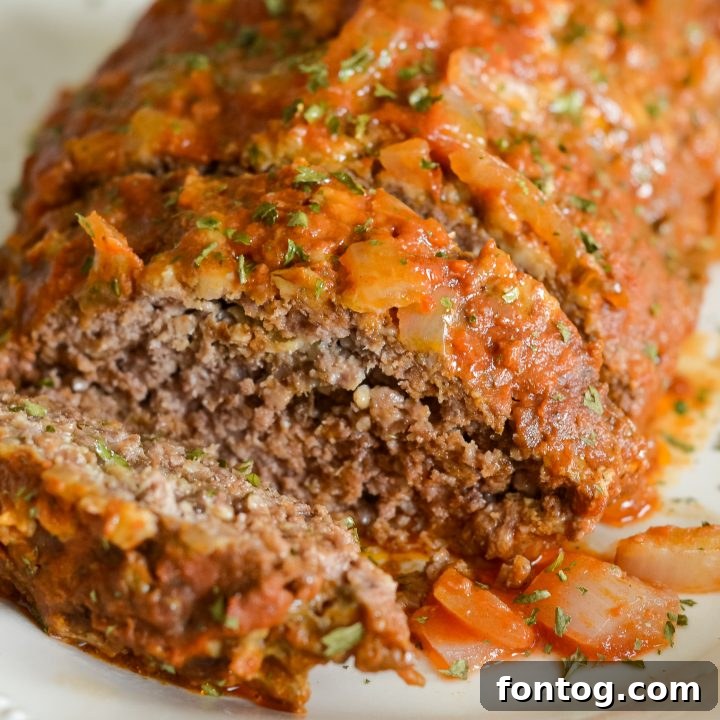 Hearty Slow Cooker Meatloaf, perfectly cooked and topped with a savory glaze, a classic comfort food.