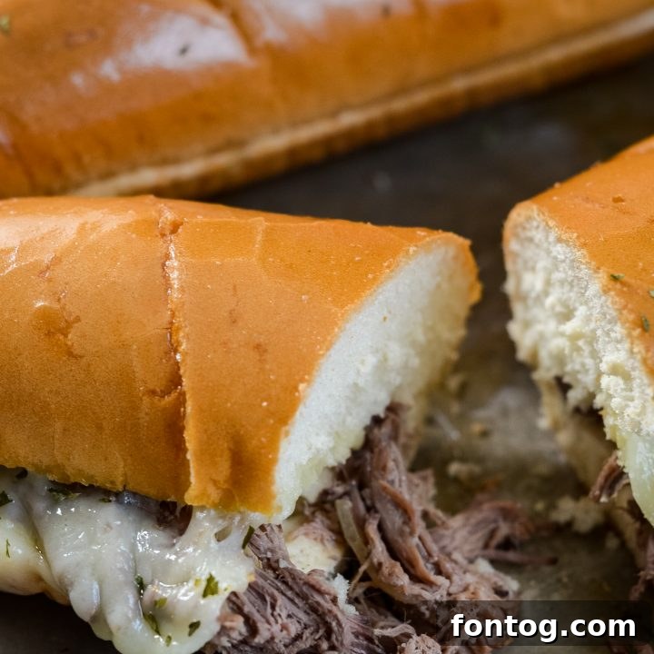Juicy Slow Cooker French Dip Sandwiches with savory au jus, served on crusty bread, ideal for an easy dinner.