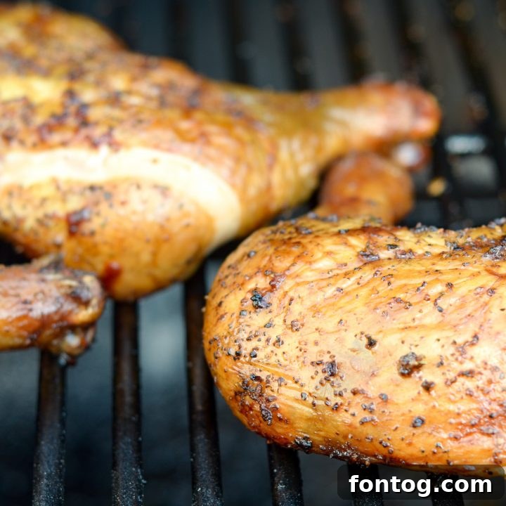 Perfectly smoked chicken quarters with a crispy, seasoned skin, ideal for a delicious summer cookout.