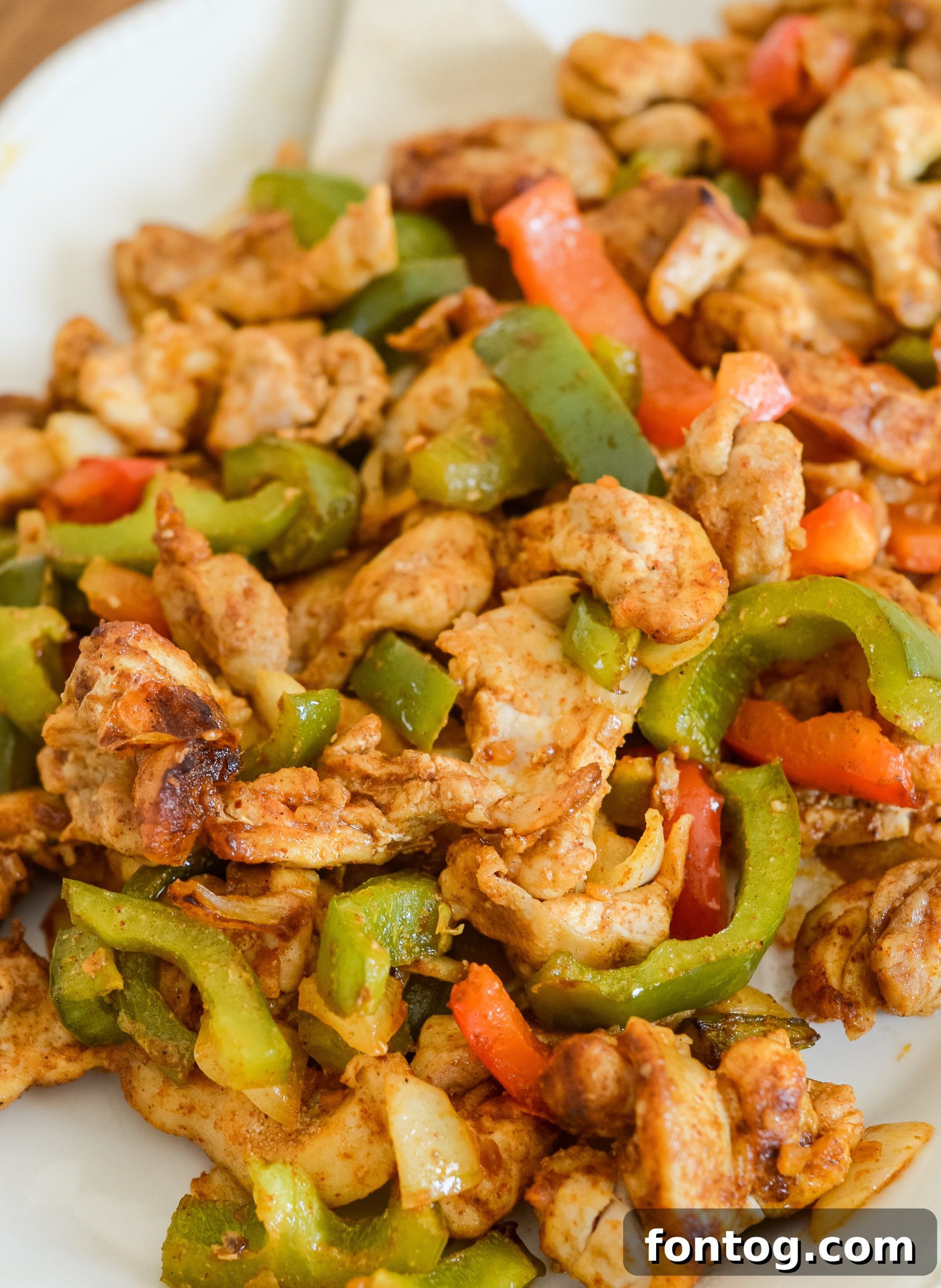 Your Weekly Meal Plan: September 15th 2 Appetizing air fryer chicken fajitas with vibrant peppers and onions, showcasing a delicious and easy meal option.