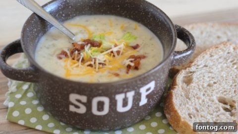 Creamy loaded mashed potato soup generously topped with crispy bacon, melted cheese, and fresh chives.