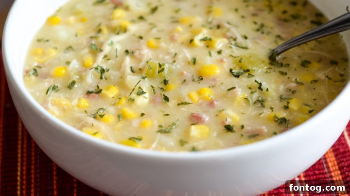 Bowl of Slow Cooker Creamy Chicken and Corn Chowder with garnish