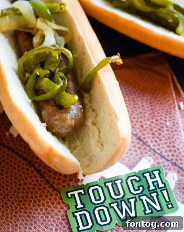 Air Fryer Beer Brats served in buns with onions and peppers, ready for tailgating